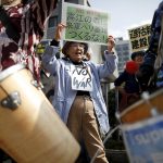 People protesting the planned relocation of the U.S. military base to Okinawa's Henoko coast shout slogans, at a rally in front of Prime Minister Shinzo Abe's official residence, as a meeting between Okinawa Governor Takeshi Onaga and Abe is holding, in Tokyo April 17, 2015. Abe met with Onaga on Friday to discuss the issue of the planned relocation of the U.S. Marines' airbase in Okinawa. A clash between Japan's central government and Okinawa island, host to the bulk of U.S. troops in Japan, deepened last Month when the southern island's governor ordered a halt to underwater work at the site of a planned relocation of a U.S. Marine base. REUTERS/Issei Kato - RTR4XOT2