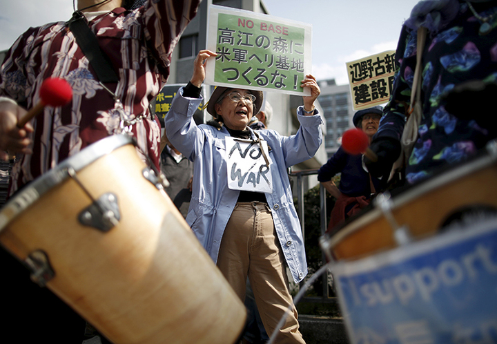 People protesting the planned relocation of the U.S. military base to Okinawa's Henoko coast shout slogans, at a rally in front of Prime Minister Shinzo Abe's official residence, as a meeting between Okinawa Governor Takeshi Onaga and Abe is holding, in Tokyo April 17, 2015. Abe met with Onaga on Friday to discuss the issue of the planned relocation of the U.S. Marines' airbase in Okinawa. A clash between Japan's central government and Okinawa island, host to the bulk of U.S. troops in Japan, deepened last Month when the southern island's governor ordered a halt to underwater work at the site of a planned relocation of a U.S. Marine base. REUTERS/Issei Kato - RTR4XOT2