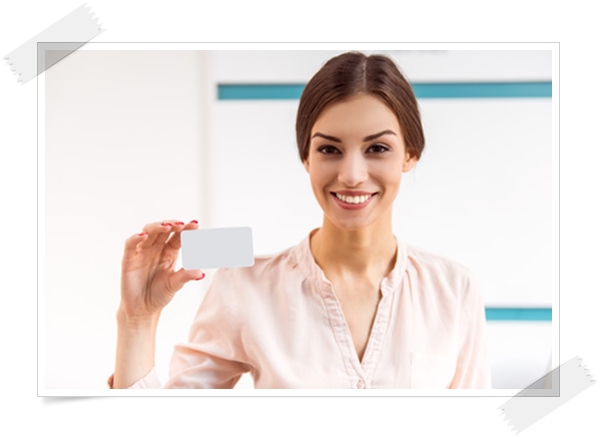 Portrait of a young woman who keeps the in the hands card of the patient