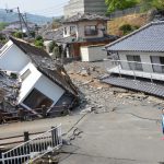 April 19, 2016, Kumamoto, Japan - A woman walks past collapsed houses at Mashiki town in Kumamoto prefecture on Tuesday, April 19, 2016. More than 40 people died and some 1,000 injured as massive earthquakes attacked Japan's southern island of Kyushu. (Photo by Yoshio Tsunoda/AFLO) LWX -ytd-